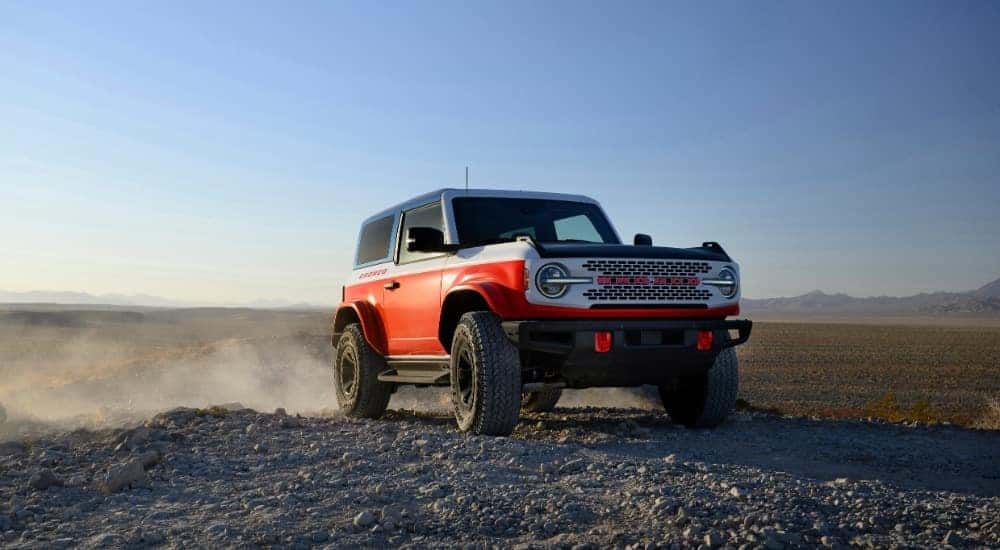 A red 2025 Ford Bronco Stroppe Special Edition off-roading.