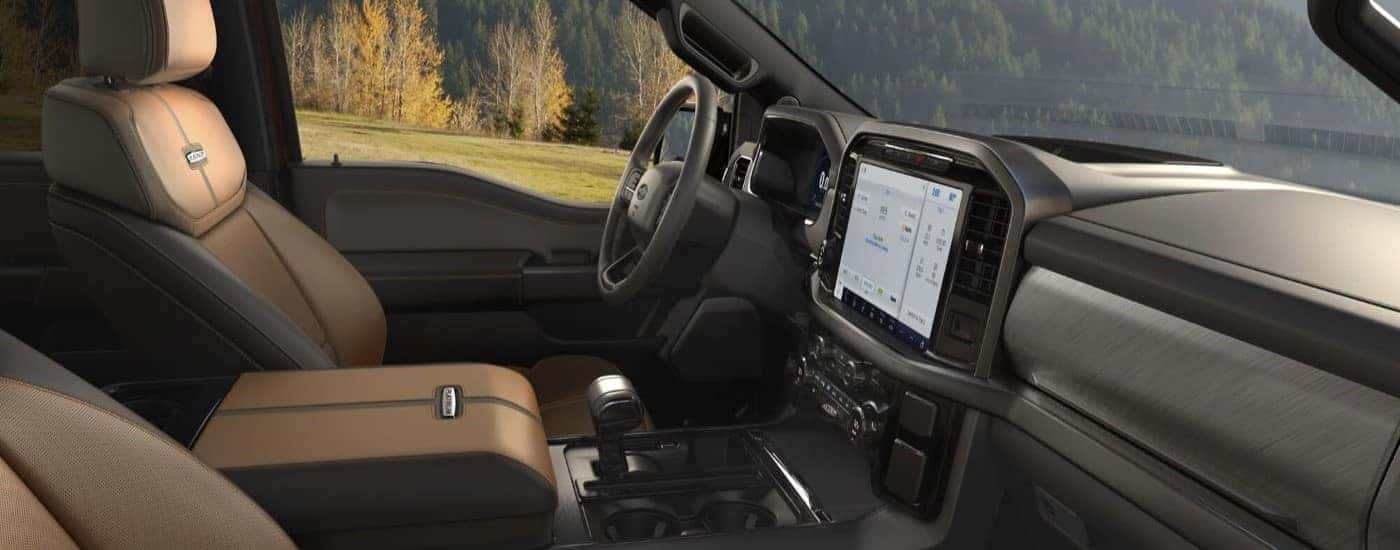 Side angle view of the black and grey interior of a 2024 Ford F-150 Platinum.