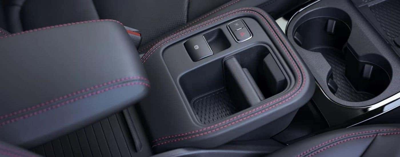The black and red accented center console of a 2025 Ford Mustang Mach-E Premium Sport for sale near Monterery.
