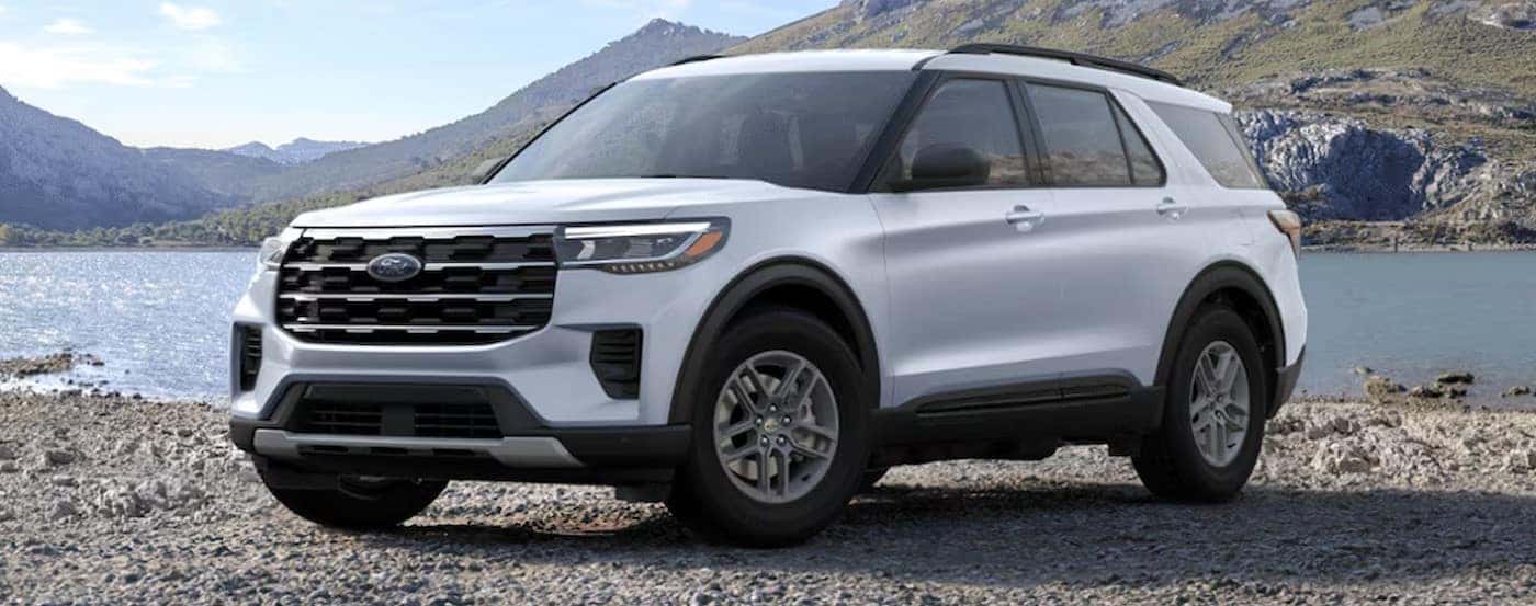 A white 2025 Ford Explorer Active parked off-road.