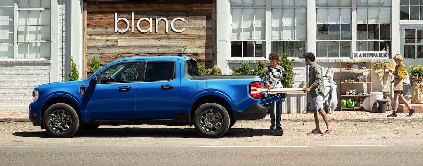 A blue 2025 Ford Maverick parked after visiting a Ford dealer near Seaside.