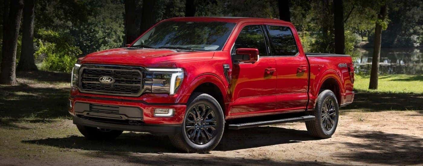 A red 2024 Ford F-150 parked at a Ford dealer near me.