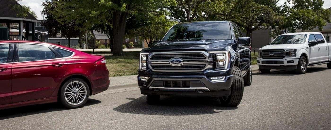 A black 2023 Ford F-150 pulling out of park.