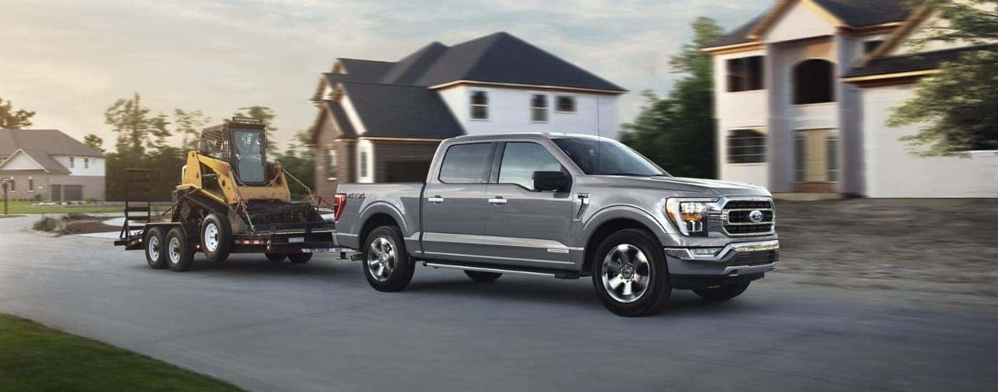 A grey 2024 Ford F-150 for sale near Watsonville towing a trailer.