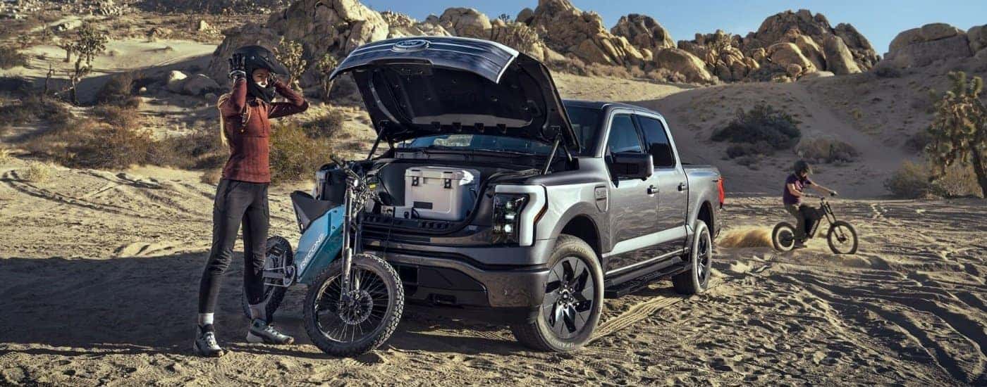 A grey 2023 Ford F-150 Lightning for sale near Capitola parked off-road.