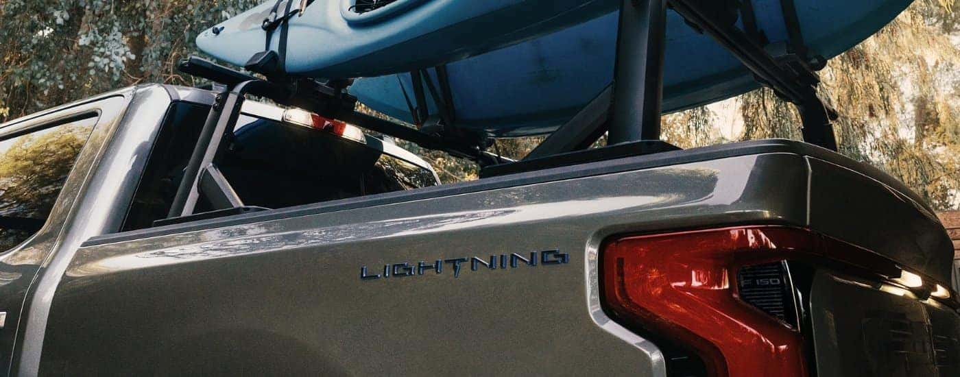 Blue kayaks on a grey 2025 Ford F-150 Lightning.
