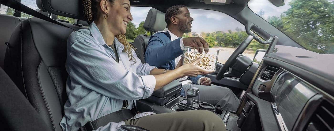 People eating popcorn in a 2025 Ford F-150 Lightning.