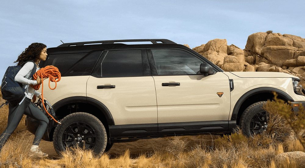 White 2025 Ford Bronco Sport Badlands for sale with a person walking away holding rope.