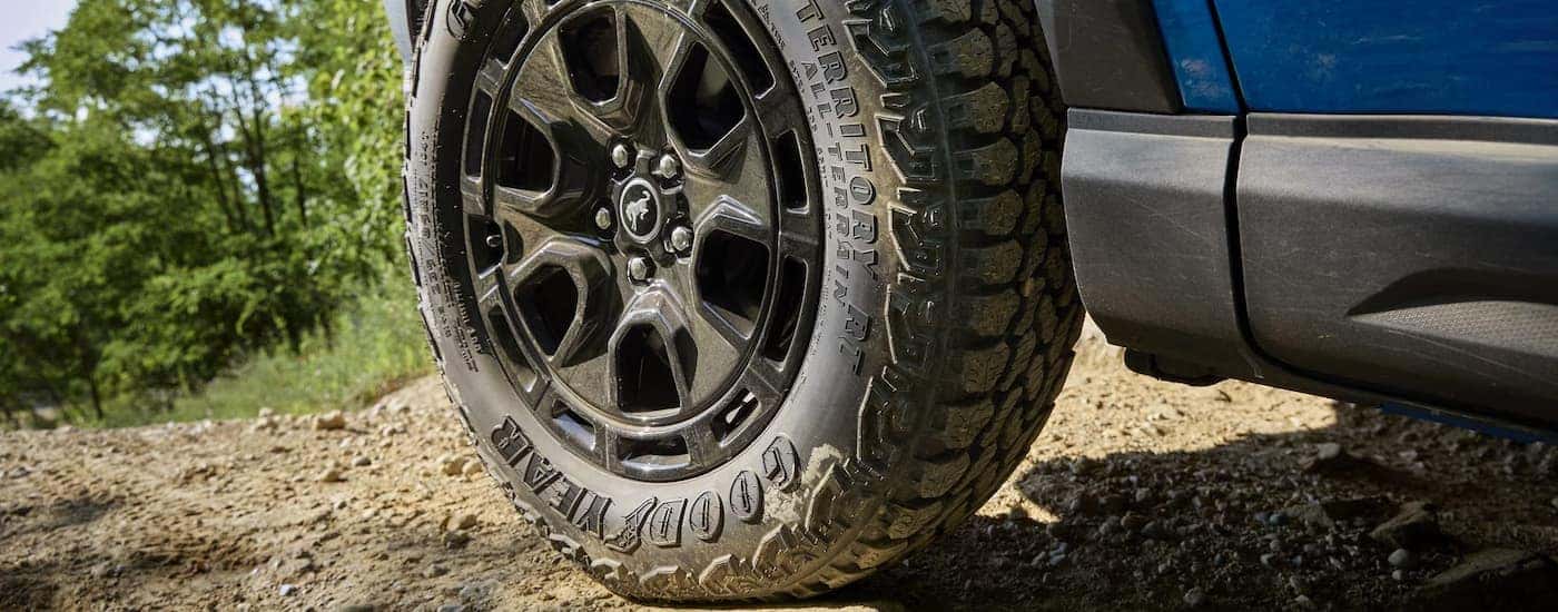 Tire and rim on a blue 2025 Ford Bronco Sport parked off-road