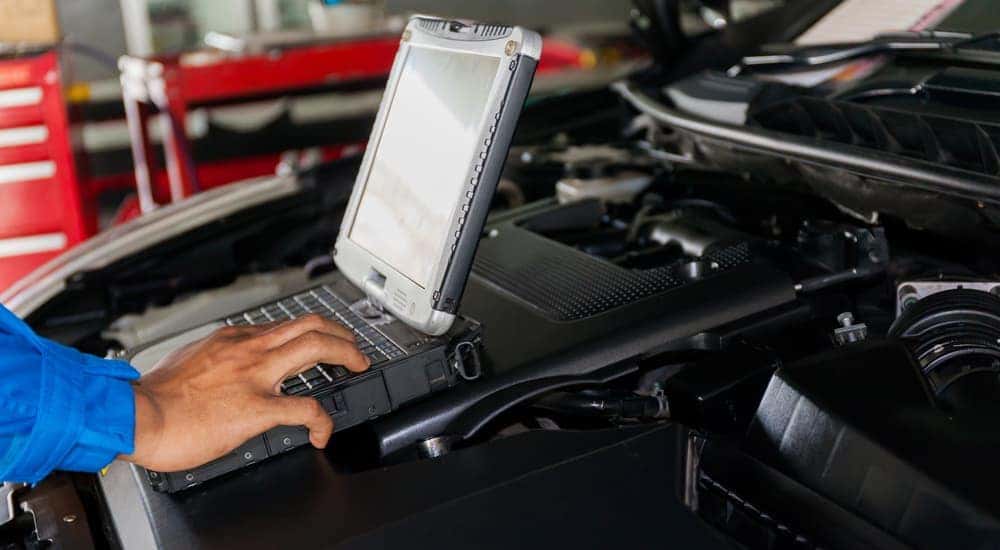 A shop tech looks at a laptop