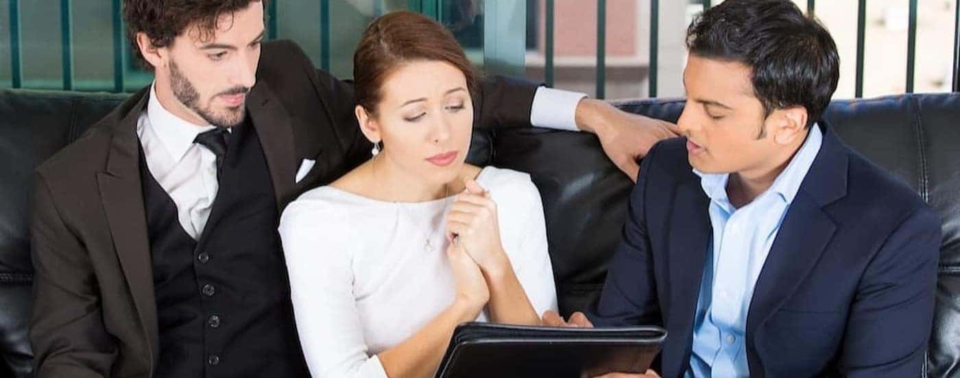 Three people reviewing documents.