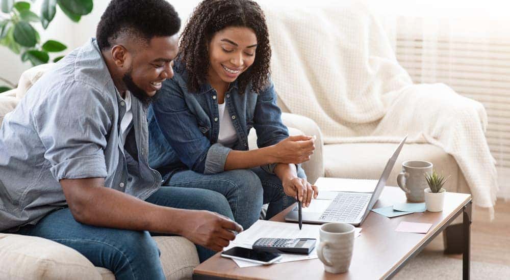 A couple is going over their budget to buy a sell a used car