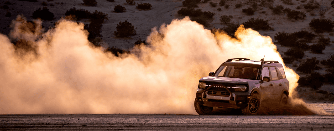 Red 2025 Ford Bronco Sport drifting through sand