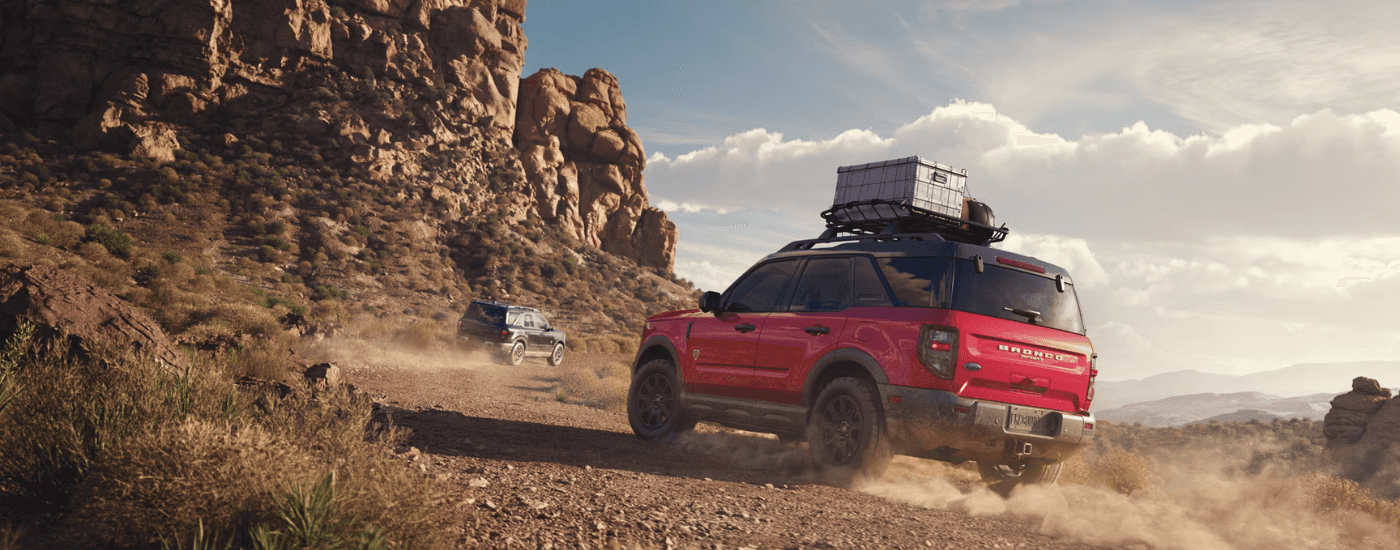 A red and a black 2025 Ford Bronco Sport driving off road