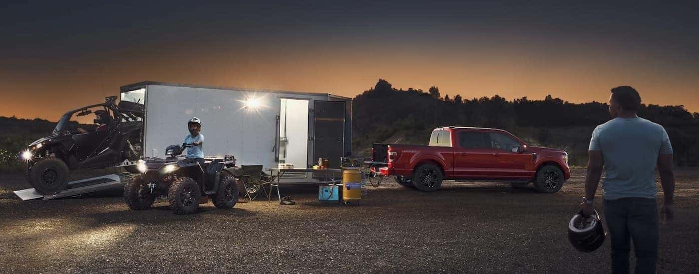 A red 2025 Ford F-150 from the side.