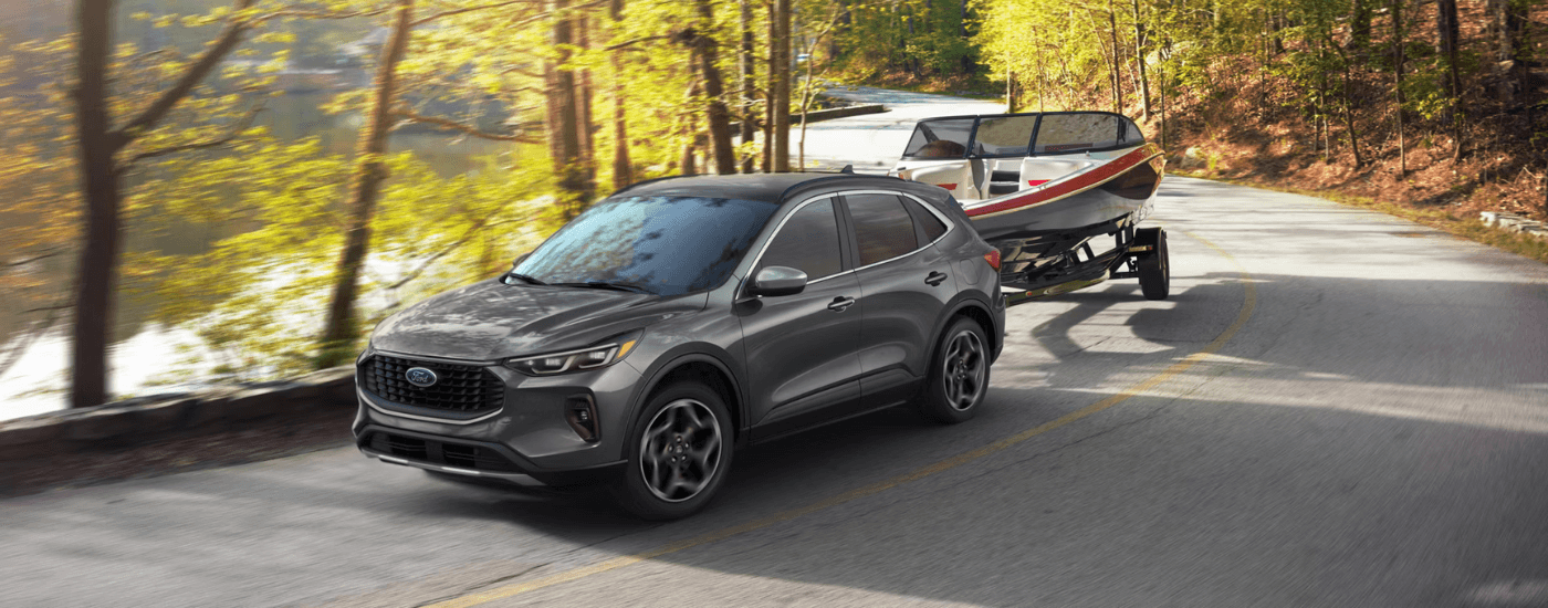 Black 2026 Ford Escape towing a boat