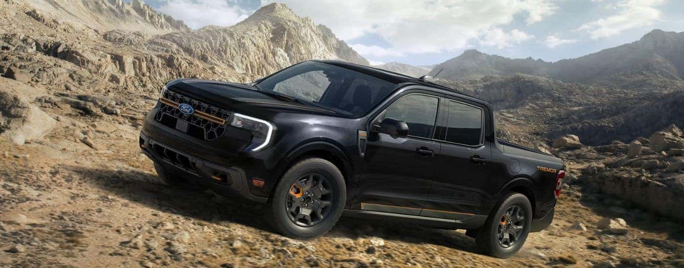 Black 2026 Ford Maverick Tremor driving up a rocky mountainside