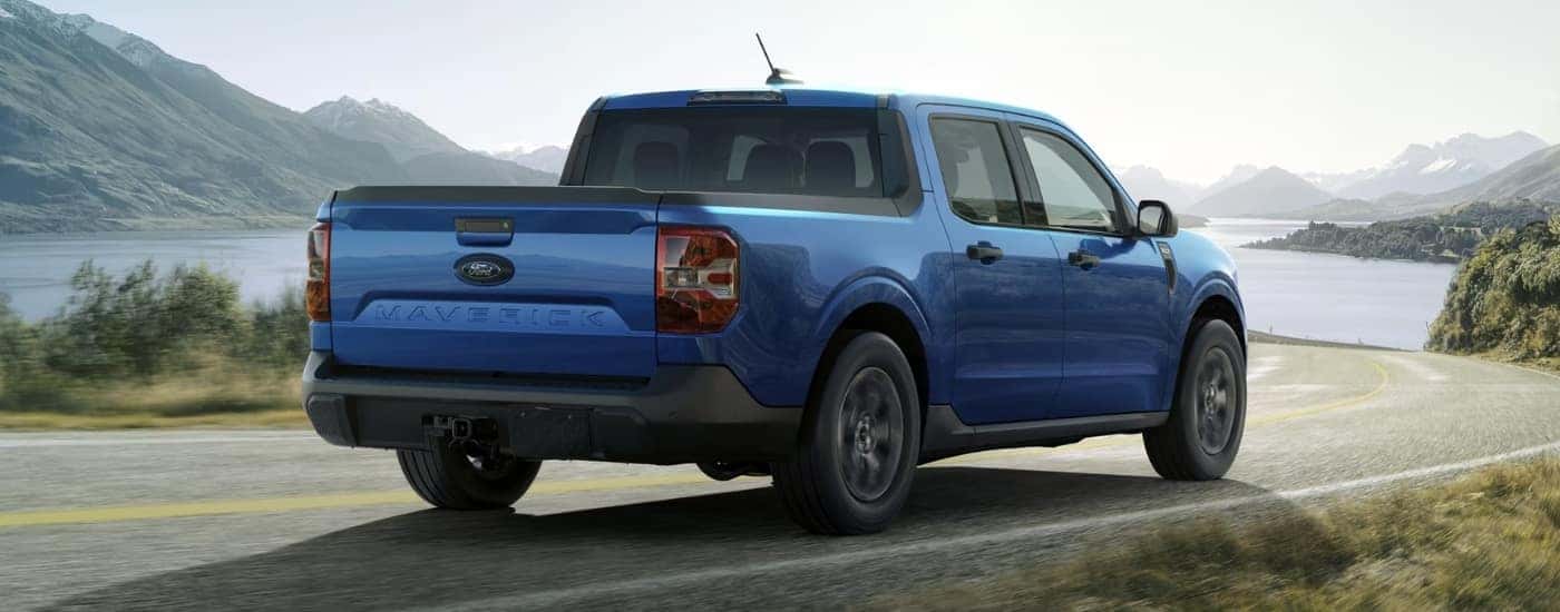 Blue 2026 Ford mAverick XLT driving along a winding road