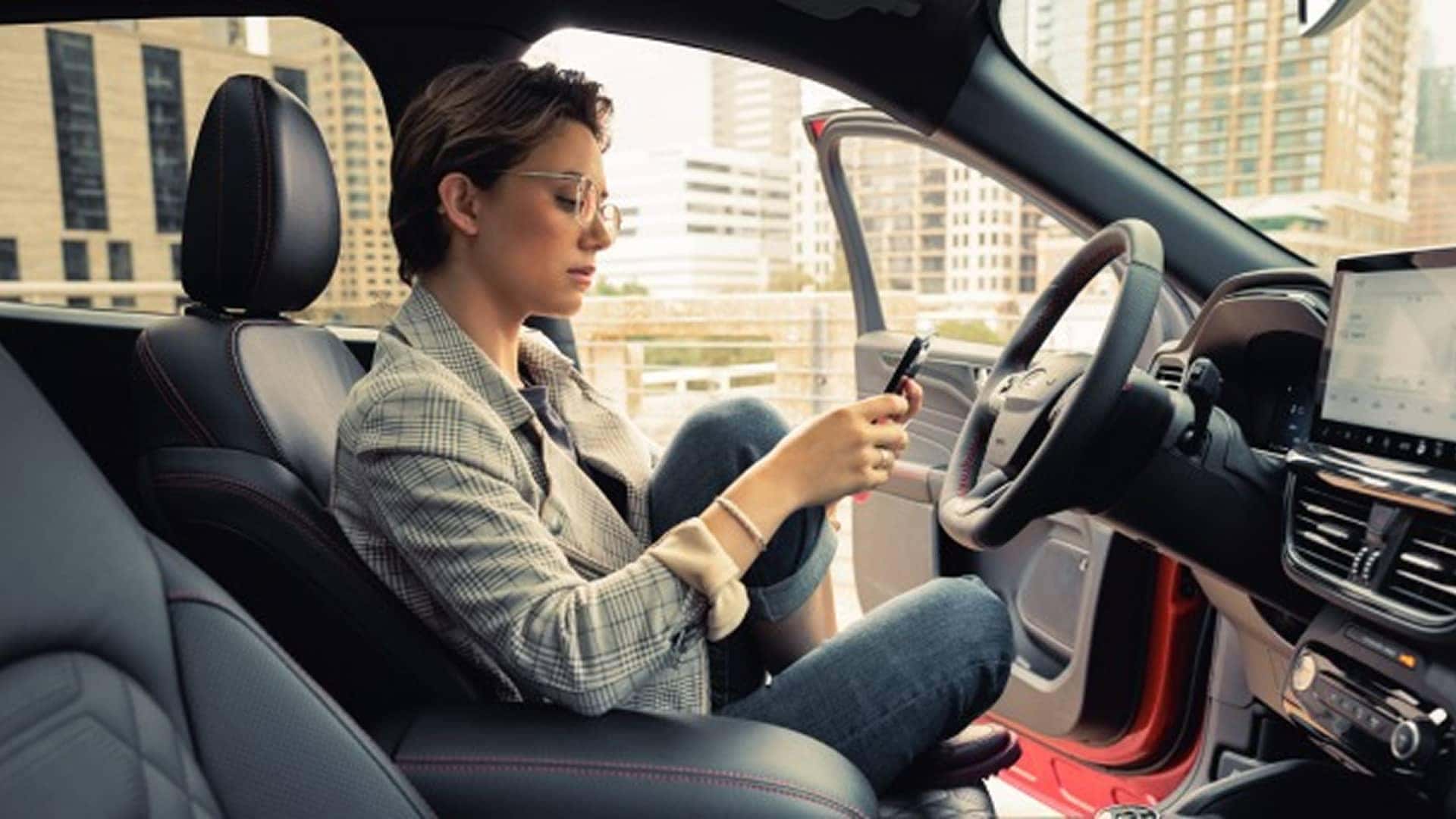 woman looking at fordpass app on phone