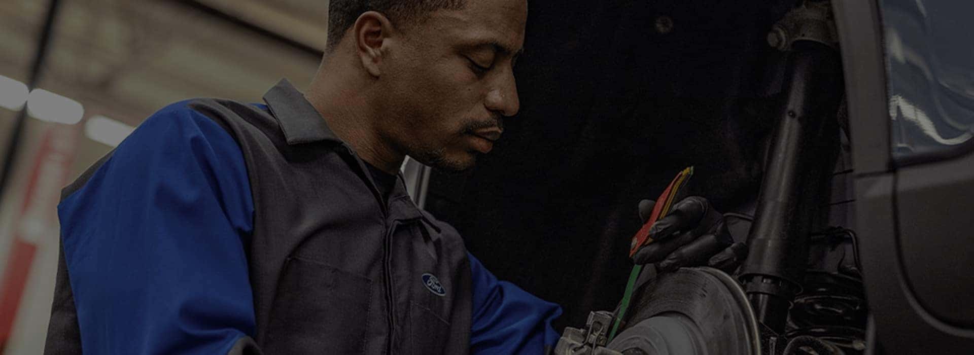 ford service tech working on vehicle