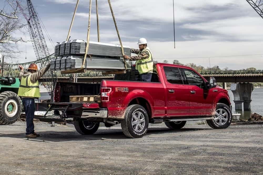 a red ford truck being loaded
