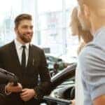 Car salesperson with clients