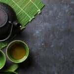Tea Kettle and Tea Cups on a Mat