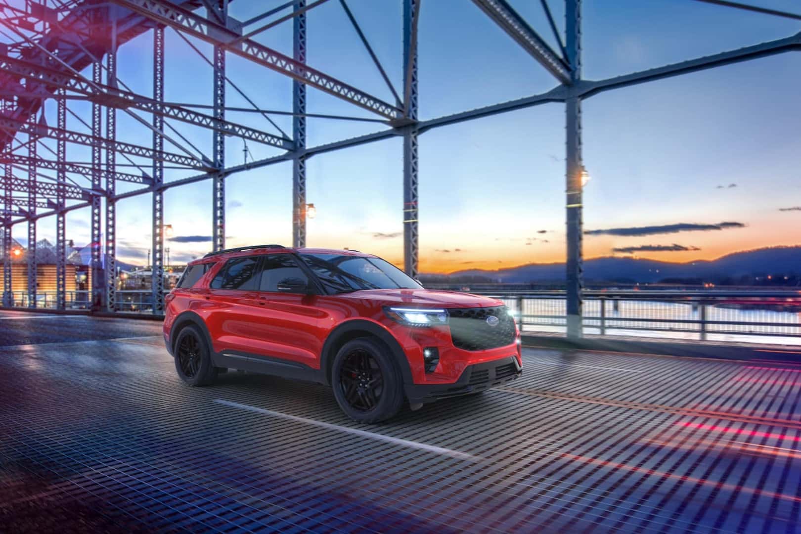 Ford Explorer driving over bridge with sunset background - Ford Dealer near Wolcott CT