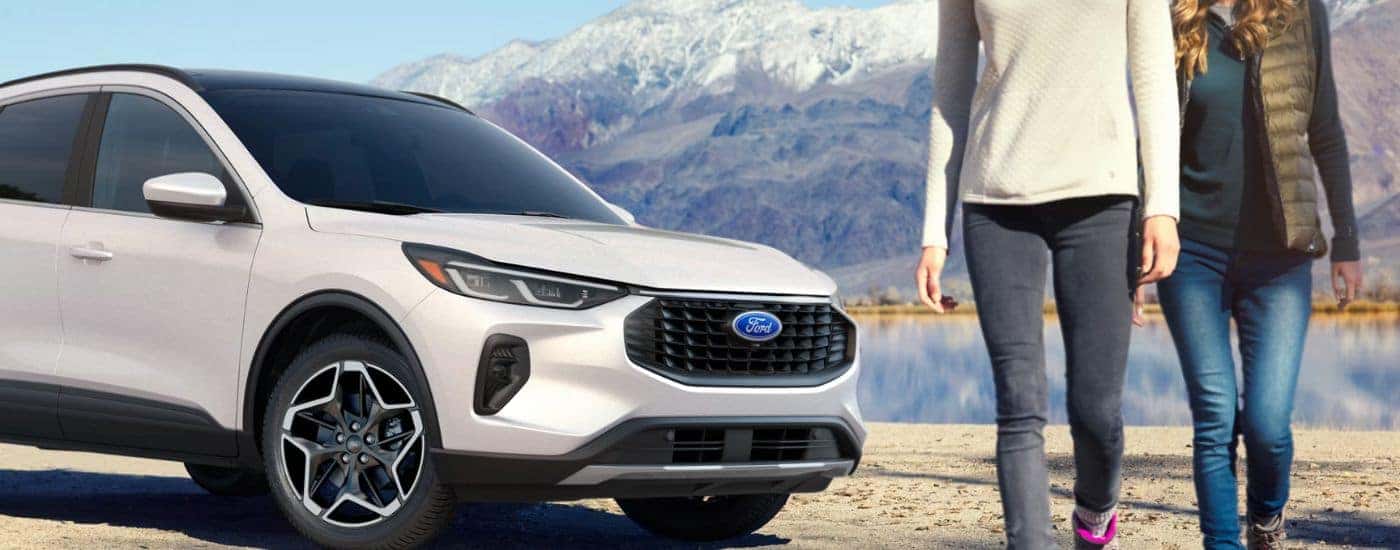White 2026 Ford Escape parked near a lake with passengers leaving