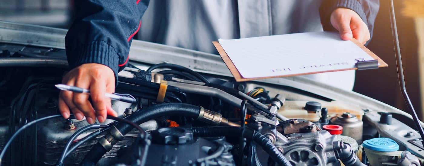 A mechanic is inspecting a vehicle engine.