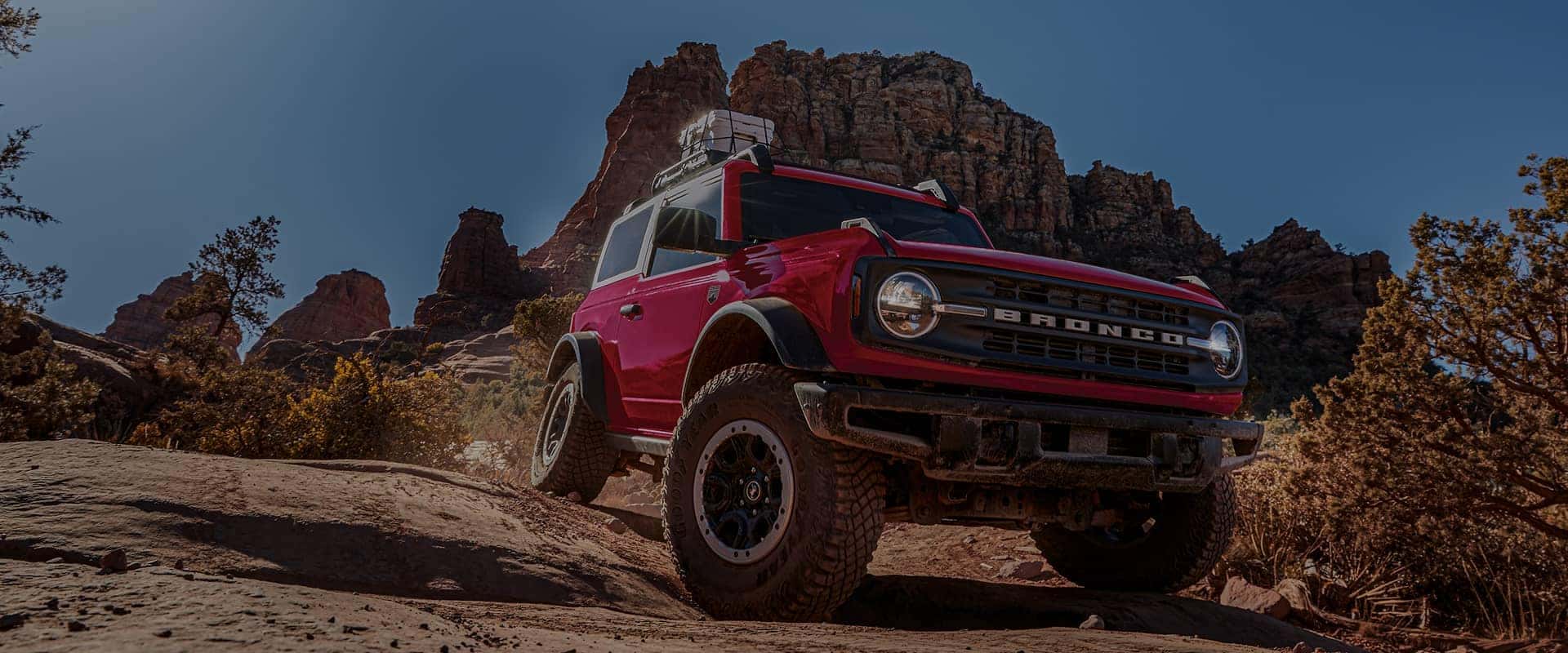 Red Ford Bronco driving off-road