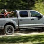 Carbonized Gray Metallic Ford F-150 2024 carrying motorcycle