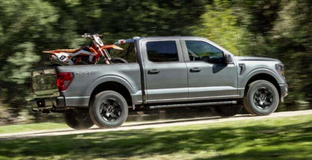 Carbonized Gray Metallic Ford F-150 2024 carrying motorcycle