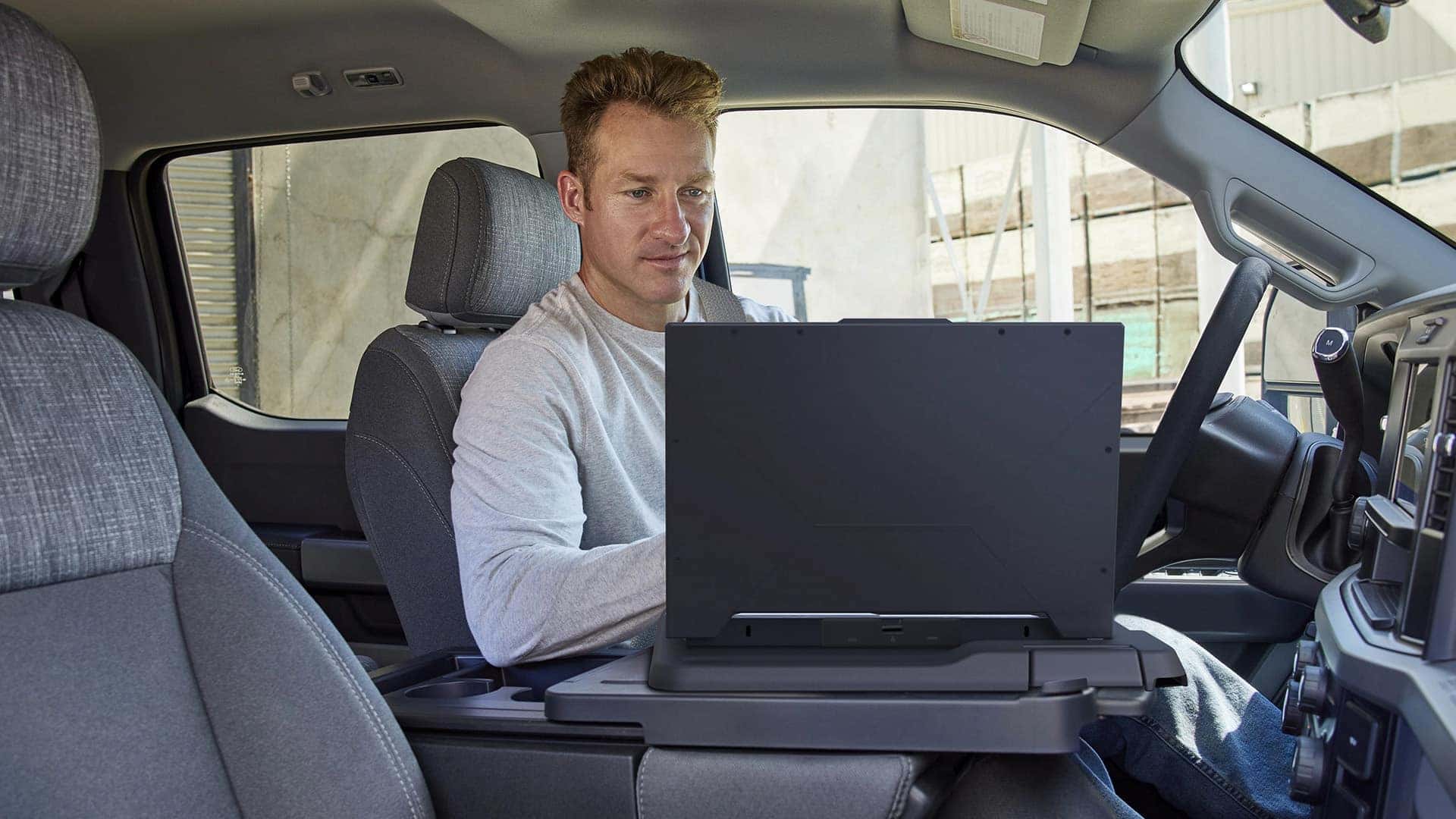 Man Using Laptop in 2026 Ford Super Duty