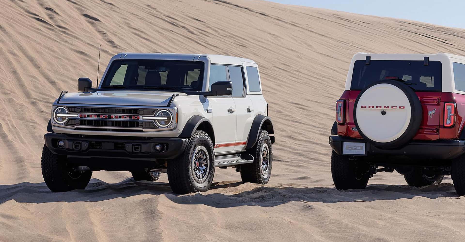 Side-view-of-white-bronco-with-red-bronco-next-to-it