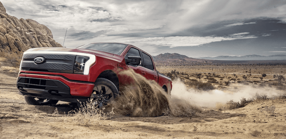 Ford F-150 Lightning driving through sand