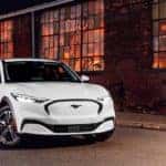white ford mach e photo next to a warehouse