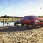 ford maverick xl on the beach towing two jetskis