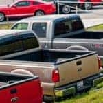 Best Ford Pickup Trucks sit in a line of their dealership.