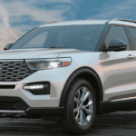 A gorgeous White Used Ford Explorer sits on a boardwalk in front of a fairground skyline.